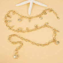 Load image into Gallery viewer, Gold chain belt with shell charms on a beige background