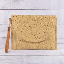 Load image into Gallery viewer, Beige woven clutch bag with a strap on a light wooden surface