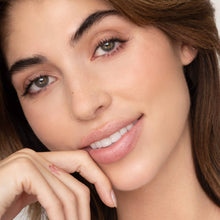 Load image into Gallery viewer, Close-up of a woman with a soft smile and hand under her chin on a neutral background with the pink Farrah lip tint on