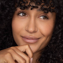 Load image into Gallery viewer, Close-up of a woman with curly hair and a soft smile wearing Poppy & Pout Faye lip tint