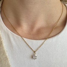 Load image into Gallery viewer, Gold necklace with a diamond pendant worn by a person on a neutral background