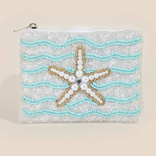 Load image into Gallery viewer, A white and blue beaded coin purse with a pearl starfish on it with white background