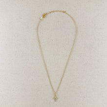 Load image into Gallery viewer, Gold necklace on a beige fabric background