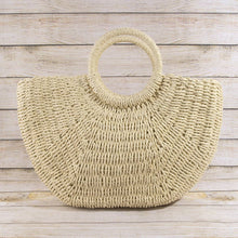 Load image into Gallery viewer, Beige woven handbag on a wooden surface