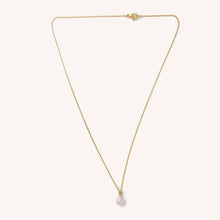 Load image into Gallery viewer, Gold necklace with a small pendant on a light beige background