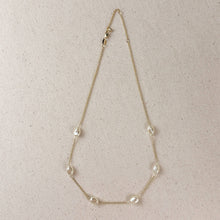 Load image into Gallery viewer, Necklace with pearls on a beige background