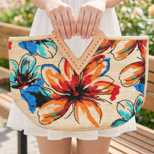 Load image into Gallery viewer, Colorful floral jute tote bag being held by a woman outside in a white sundress