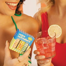 Load image into Gallery viewer, Two women holding a glass of pink drink with a lime wedge and a box of 3 retro refreshers lip balms gift set
