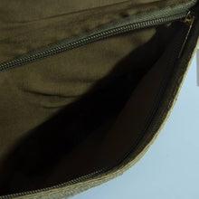 Load image into Gallery viewer, Close-up of the dark brown inside of the ivory clutch bag with a zipper on a light blue background
