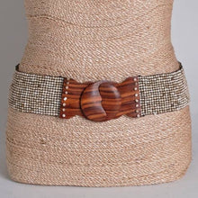 Load image into Gallery viewer, A light beige beaded belt with a wooden buckle on a woven tan mannequin with a light grey background
