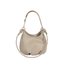 Load image into Gallery viewer, A light beige leather slouchy shoulder bag with a gold-tone metal top handle and a matching adjustable shoulder strap, shown against a plain white background.
