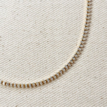 Load image into Gallery viewer, Delicate diamond necklace on a textured beige fabric background
