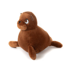 Load image into Gallery viewer, A brown sea lion squishy plush sitting upright facing the left with a white background.
