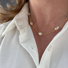 Load image into Gallery viewer, Pearl necklace worn by a person with a white shirt
