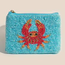 Load image into Gallery viewer, A blue beaded coin purse with a red crab on it and a white background

