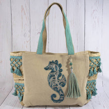 Load image into Gallery viewer, Beige tote bag with teal accents and a beaded seahorse design on a wooden surface
