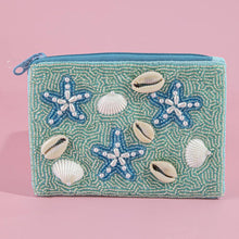 Load image into Gallery viewer, A blue and green beaded coin purse with pearl starfish and shells on a light pink background 
