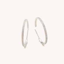Load image into Gallery viewer, Silver hoop earrings with embedded cz stones on a white background

