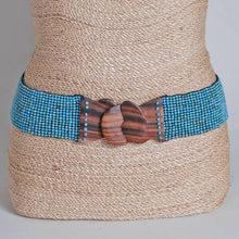 Load image into Gallery viewer, A turquoise beaded belt with a wooden buckle on a tan woven mannequin with a light grey background
